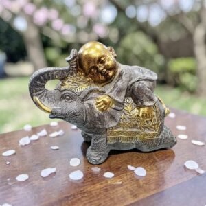 buda niño sobre elefante decorativo feng shui